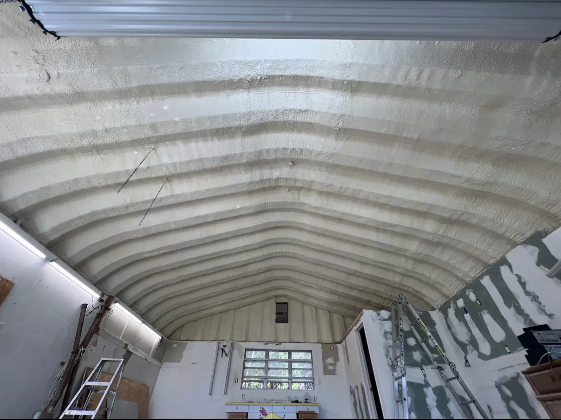 Spray polyurethane foam applied to the underside of a metal roof deck in Saraland
